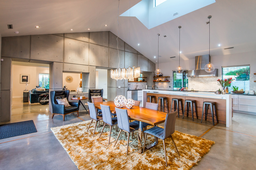 Contemporary kitchen/dining combo in Salt Lake City with grey walls, concrete floors and grey floor.