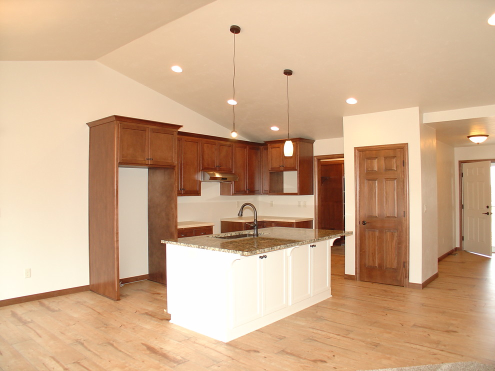 Open concept kitchen - large light wood floor open concept kitchen idea with an island