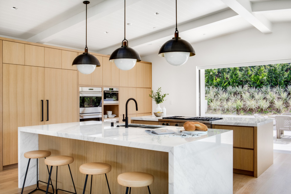 Inspiration for a midcentury kitchen in Orange County with marble benchtops, multiple islands and grey benchtop.