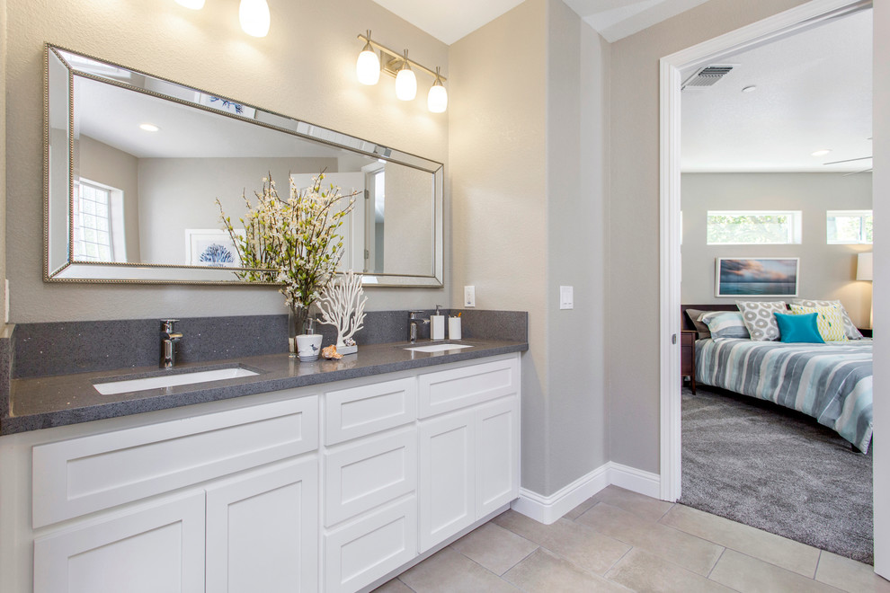 This is an example of a mid-sized transitional master bathroom in Sacramento with shaker cabinets, white cabinets, grey walls, porcelain floors, an undermount sink and grey floor.