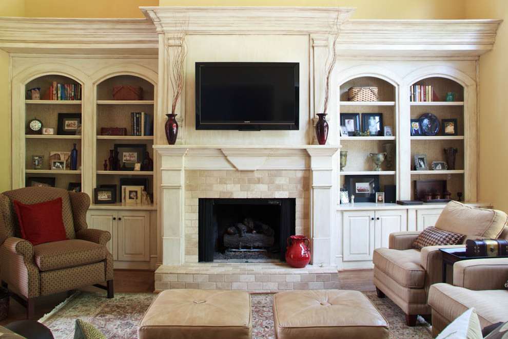 Traditional family room in Atlanta with a stone fireplace surround.