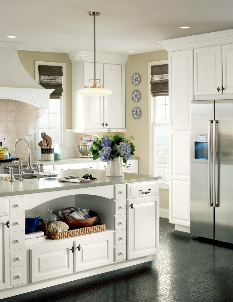 Enclosed kitchen - mid-sized transitional enclosed kitchen idea with a single-bowl sink, raised-panel cabinets, white cabinets, quartzite countertops, white backsplash, stainless steel appliances and an island