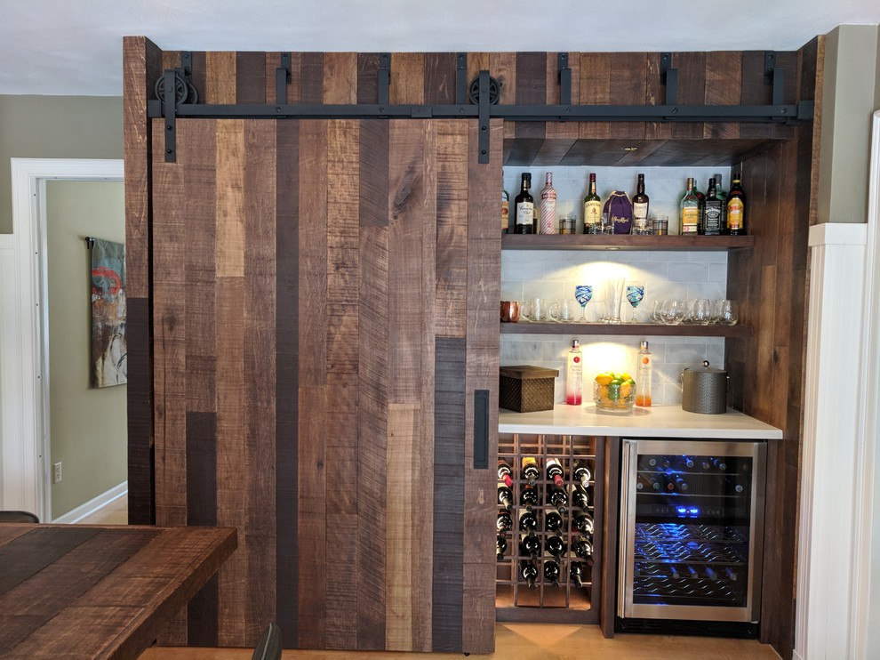 Design ideas for a mid-sized country single-wall wet bar in Other with open cabinets, dark wood cabinets, grey splashback, subway tile splashback, light hardwood floors and brown floor.