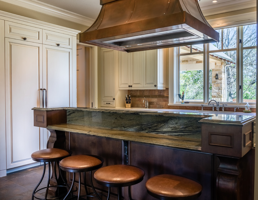Inspiration for a large country u-shaped separate kitchen in Houston with an undermount sink, raised-panel cabinets, distressed cabinets, granite benchtops, multi-coloured splashback, panelled appliances, slate floors, with island and green floor.