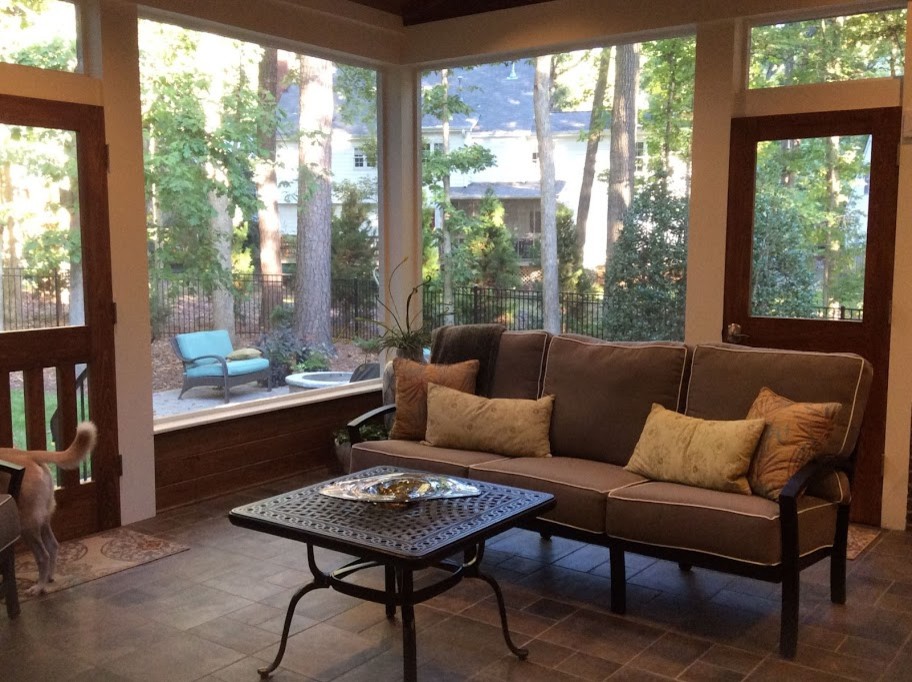 Inspiration for a mid-sized transitional backyard screened-in verandah in Raleigh with a roof extension.