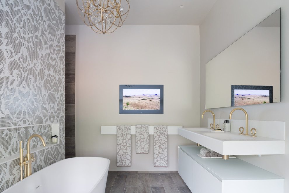 Contemporary master bathroom in Kent with flat-panel cabinets, white cabinets, a freestanding tub, an open shower, beige tile, mosaic tile, an integrated sink and an open shower.