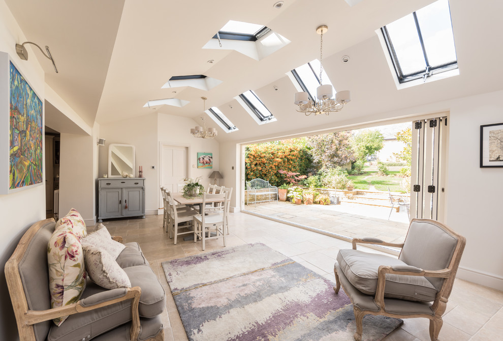 Photo of a transitional sunroom in Other with a skylight and beige floor.