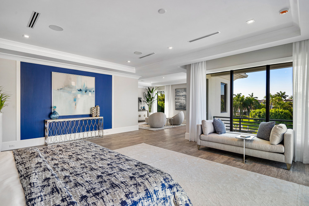 Design ideas for a contemporary master bedroom in Miami with grey walls, light hardwood floors and brown floor.