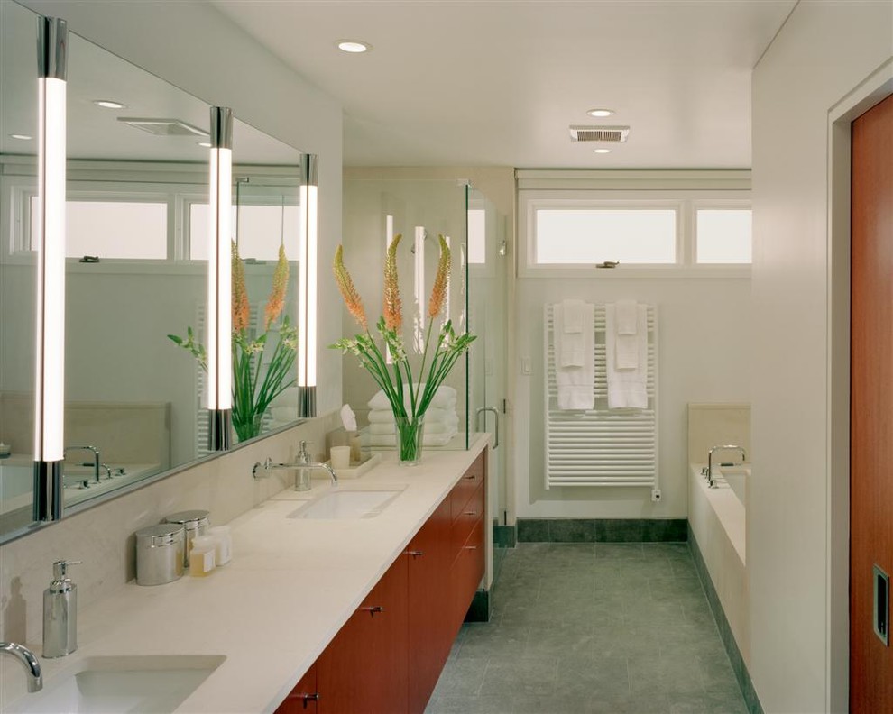 This is an example of a modern bathroom in Philadelphia with flat-panel cabinets, medium wood cabinets and an alcove shower.