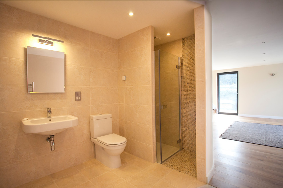 Bathroom - mid-sized contemporary beige tile single-sink bathroom idea in Cornwall