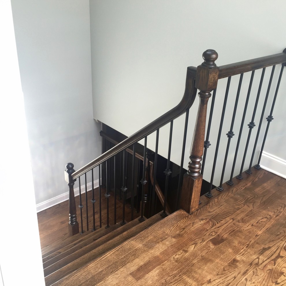 Inspiration for a mid-sized traditional wood u-shaped staircase in Chicago with wood risers and metal railing.