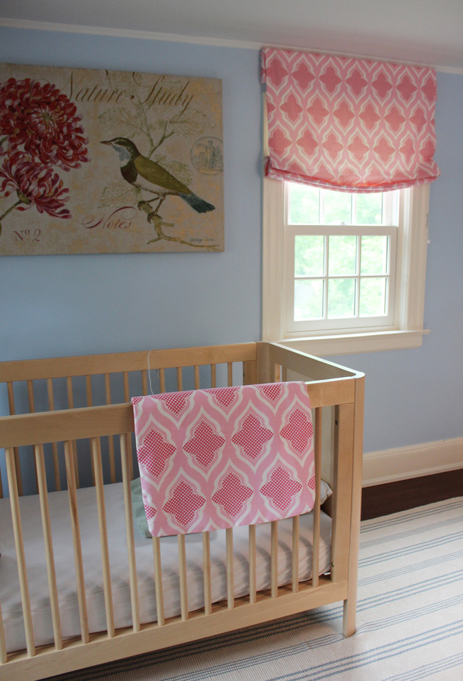 Design ideas for a medium sized modern nursery for girls in New York with blue walls and carpet.