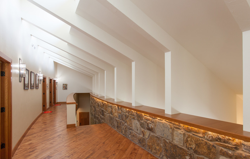This is an example of a contemporary hallway in Milwaukee with white walls, medium hardwood floors and brown floor.