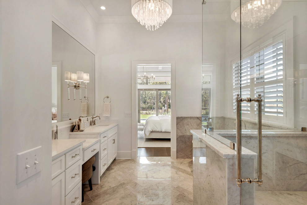 This is an example of a large beach style master bathroom in Miami with recessed-panel cabinets, white cabinets, a freestanding tub, a double shower, white walls and an undermount sink.