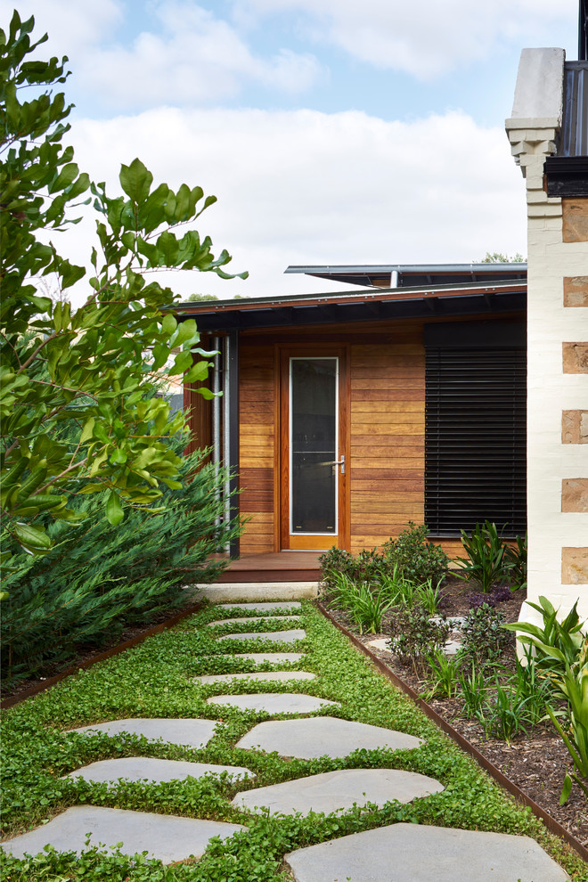Photo of a contemporary front door in Adelaide with brown walls, a single front door and a glass front door.