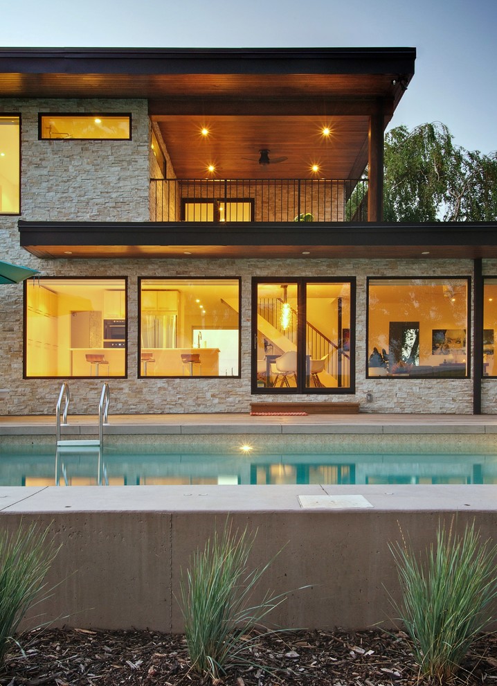 Inspiration for a contemporary two-storey exterior in Toronto with stone veneer.