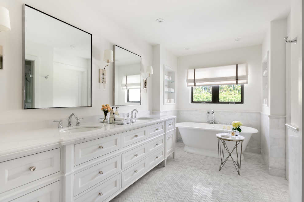 Design ideas for a traditional bathroom in Miami with recessed-panel cabinets, white cabinets, a freestanding tub, white walls, mosaic tile floors, an undermount sink, white floor, white benchtops, a double vanity, a freestanding vanity and decorative wall panelling.