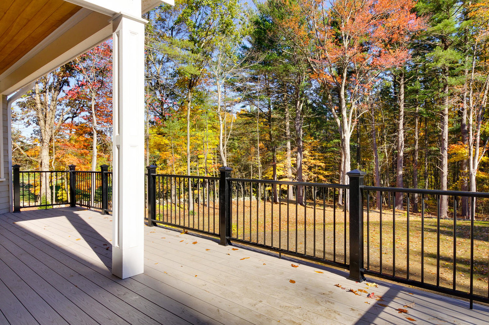 Large transitional backyard deck photo in Boston with a roof extension