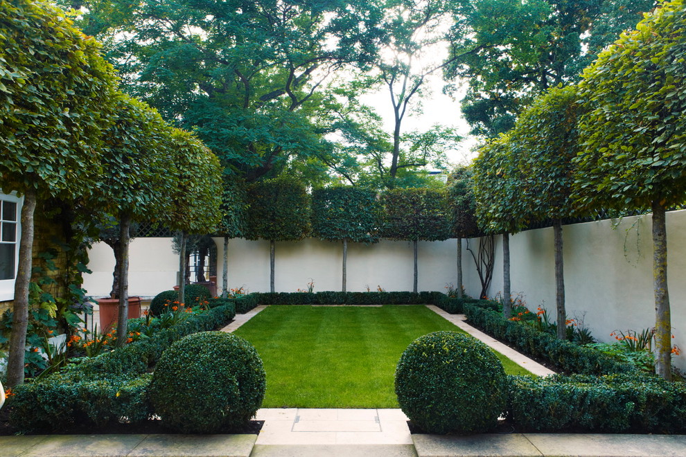 Mid-sized contemporary front yard shaded garden in London with a garden path and natural stone pavers.
