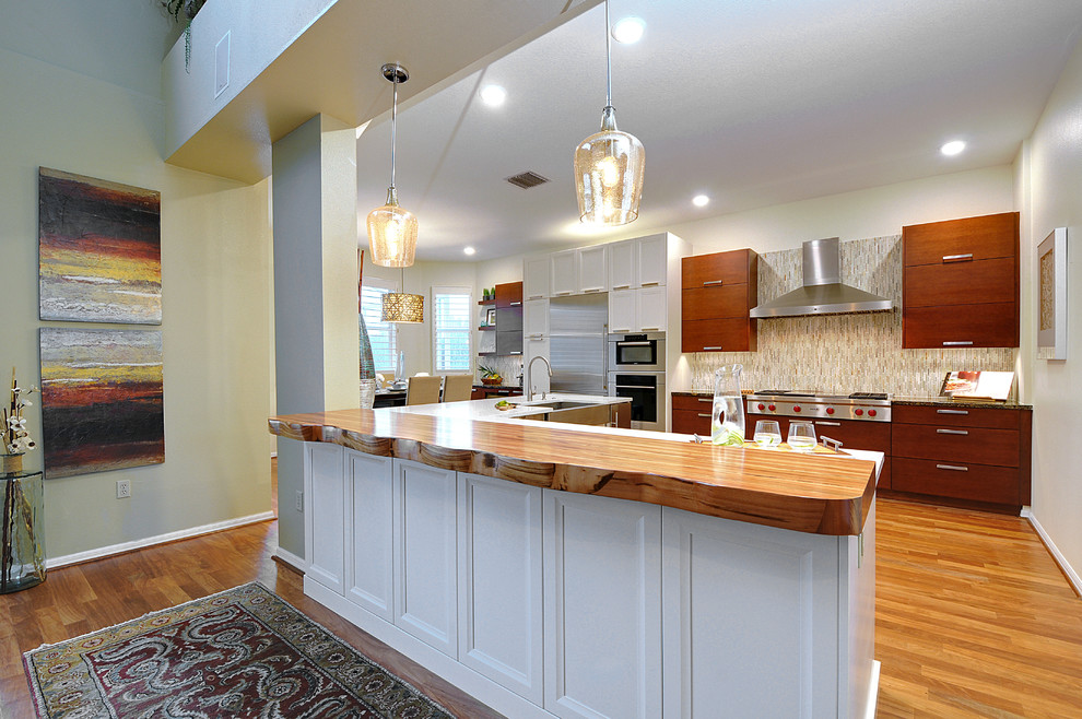 Large transitional l-shaped dark wood floor open concept kitchen photo in Tampa with a farmhouse sink, gray backsplash, matchstick tile backsplash, stainless steel appliances and an island