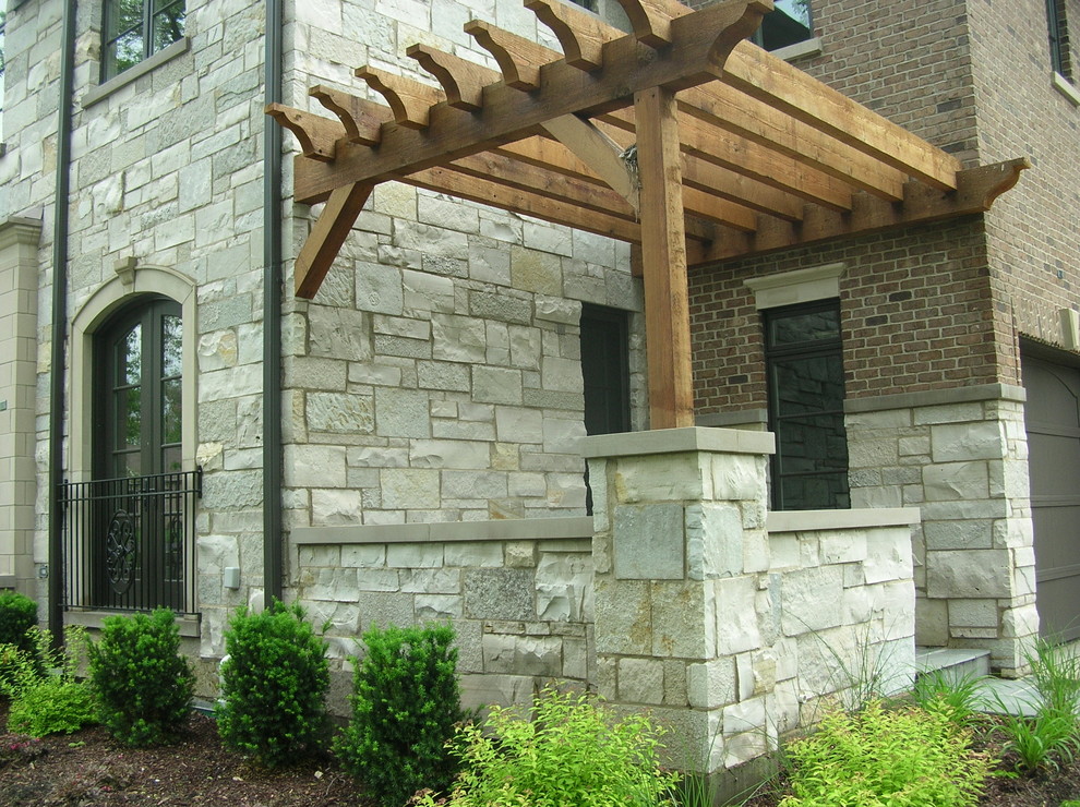 This is an example of a mid-sized modern two-storey grey exterior in Detroit with stone veneer and a gable roof.