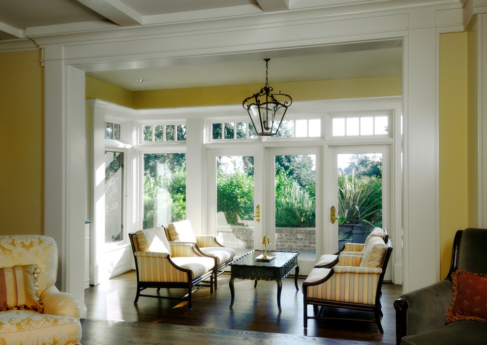 Photo of a traditional sunroom in Seattle with dark hardwood floors and a standard ceiling.