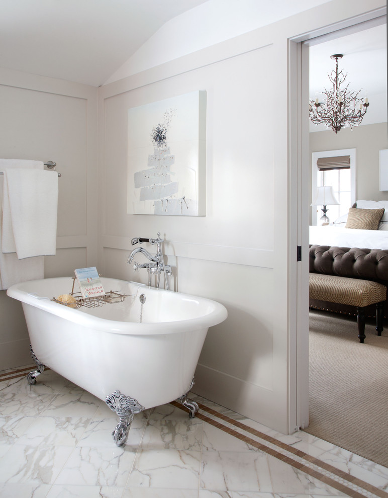 Photo of a traditional bathroom in Denver with a claw-foot tub and marble floors.
