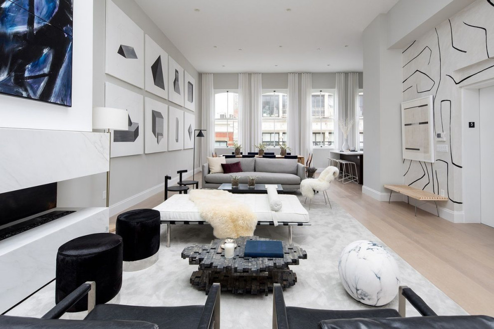 Photo of a large contemporary loft-style living room in New York with grey walls and beige floor.