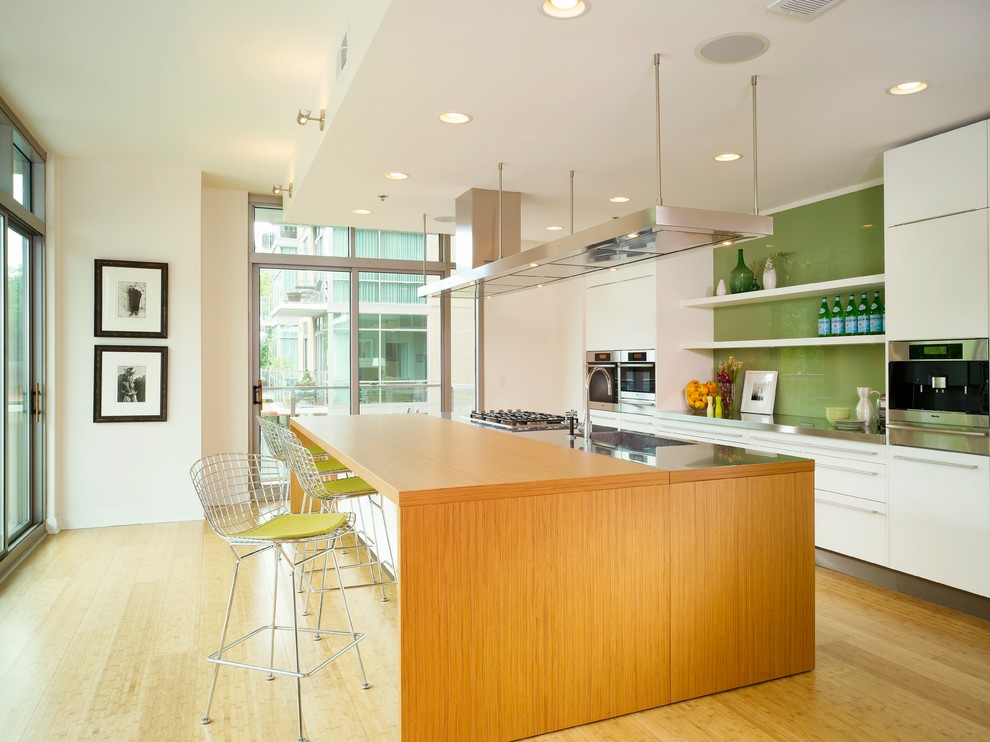 Inspiration for a modern kitchen in Atlanta with flat-panel cabinets, green splashback, glass sheet splashback and white cabinets.