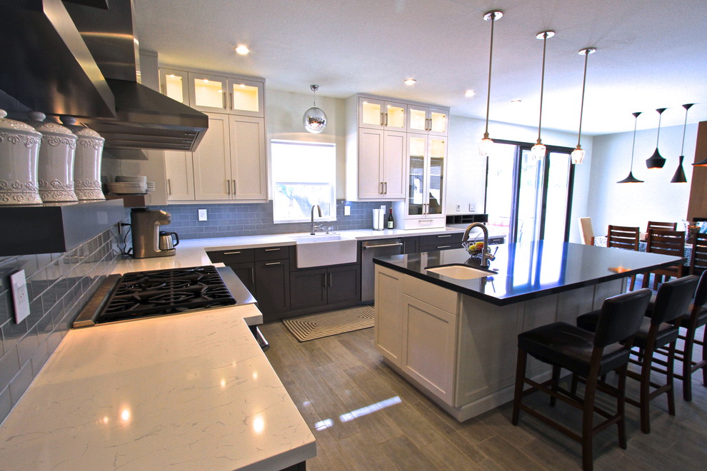 Transitional porcelain tile kitchen photo in Orange County with glass tile backsplash and an island
