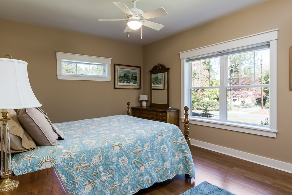Photo of a mid-sized beach style guest bedroom in Raleigh with beige walls and bamboo floors.