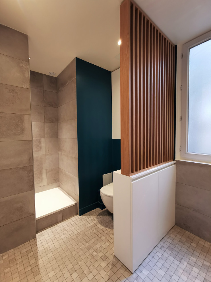 Photo of a medium sized contemporary grey and white ensuite bathroom in Paris with flat-panel cabinets, a built-in shower, a wall mounted toilet, grey tiles, stone tiles, blue walls, mosaic tile flooring, a built-in sink, laminate worktops, grey floors, grey worktops, a single sink, a built in vanity unit and wood walls.