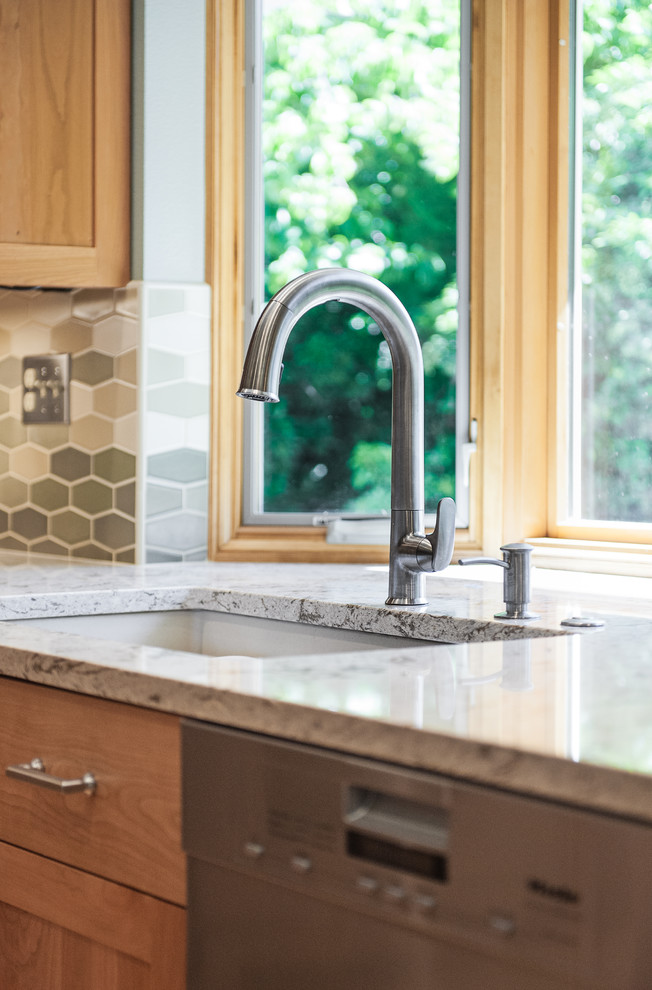 Eat-in kitchen - large transitional l-shaped cork floor eat-in kitchen idea in Portland with a single-bowl sink, recessed-panel cabinets, medium tone wood cabinets, quartz countertops, beige backsplash, ceramic backsplash, stainless steel appliances and an island
