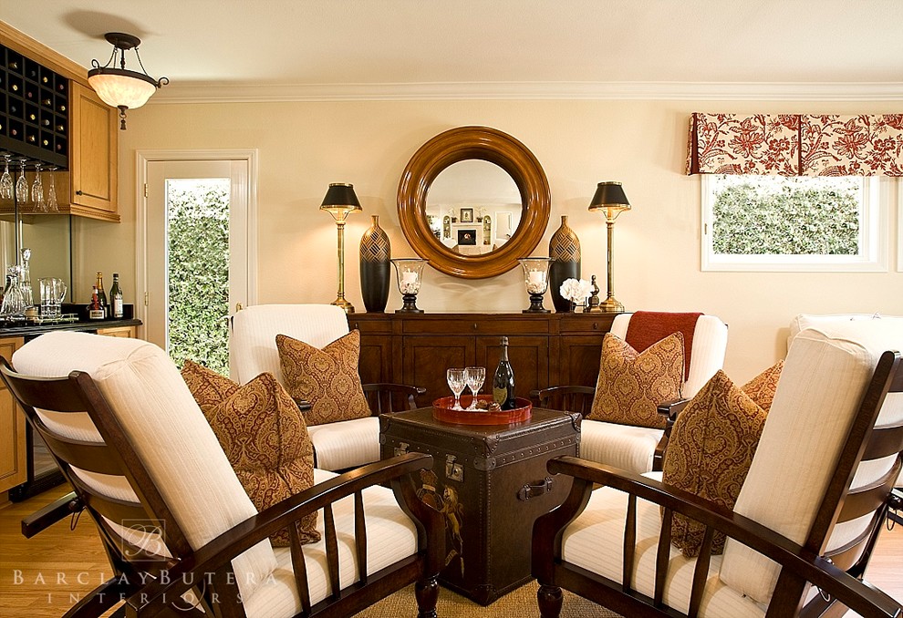This is an example of a transitional family room in Orange County with a home bar, beige walls and light hardwood floors.