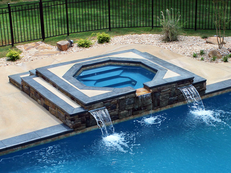 Example of a large transitional backyard concrete paver and rectangular hot tub design in Chicago