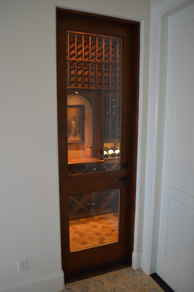 This is an example of a mid-sized asian wine cellar in Orange County with display racks.