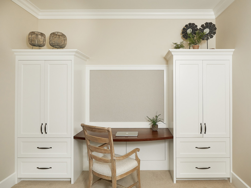Photo of a small traditional study room in Grand Rapids with beige walls, ceramic floors, a built-in desk and beige floor.