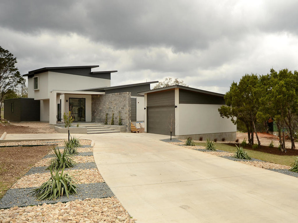 This is an example of a contemporary two-storey white exterior in Austin.