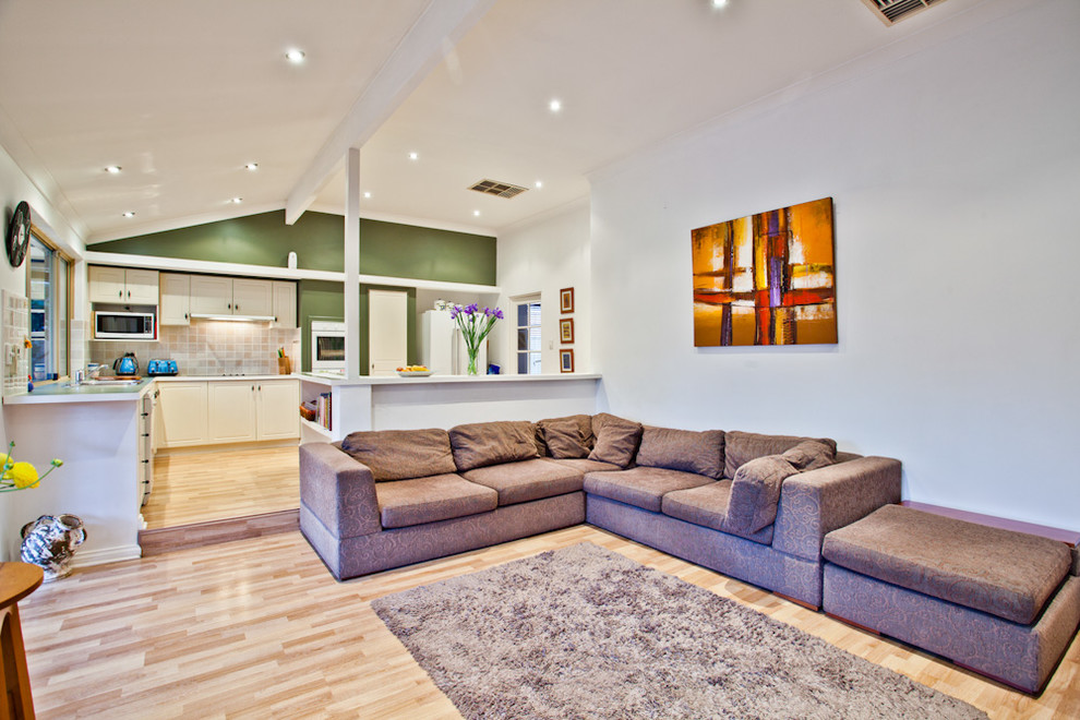 Photo of a contemporary living room in Perth with white walls and light hardwood floors.