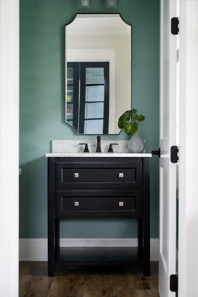 Photo of a medium sized country cloakroom in Indianapolis with shaker cabinets, brown cabinets, green walls, a submerged sink, granite worktops, white worktops and a built in vanity unit.