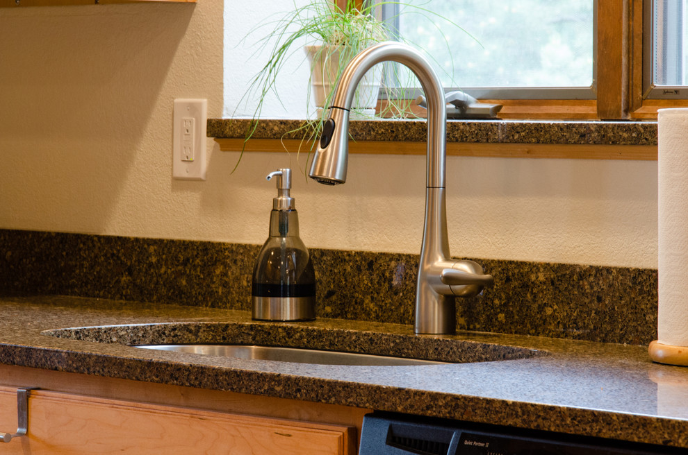 Mid-sized transitional u-shaped light wood floor and brown floor enclosed kitchen photo in Denver with a double-bowl sink, recessed-panel cabinets, light wood cabinets, granite countertops, stainless steel appliances and no island