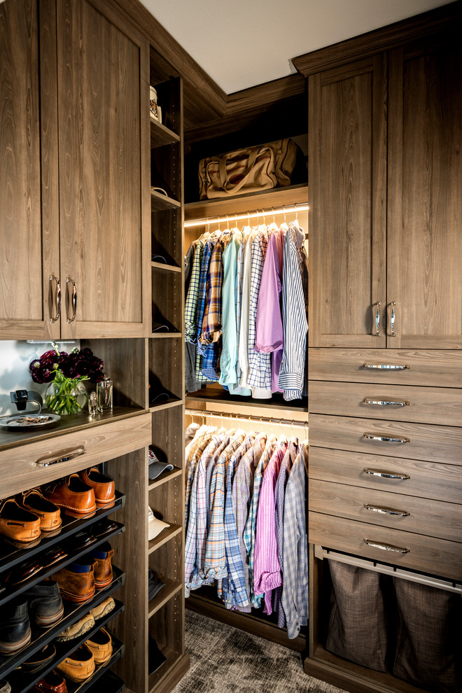 Design ideas for a small modern men's walk-in wardrobe in Other with recessed-panel cabinets, medium wood cabinets and carpet.