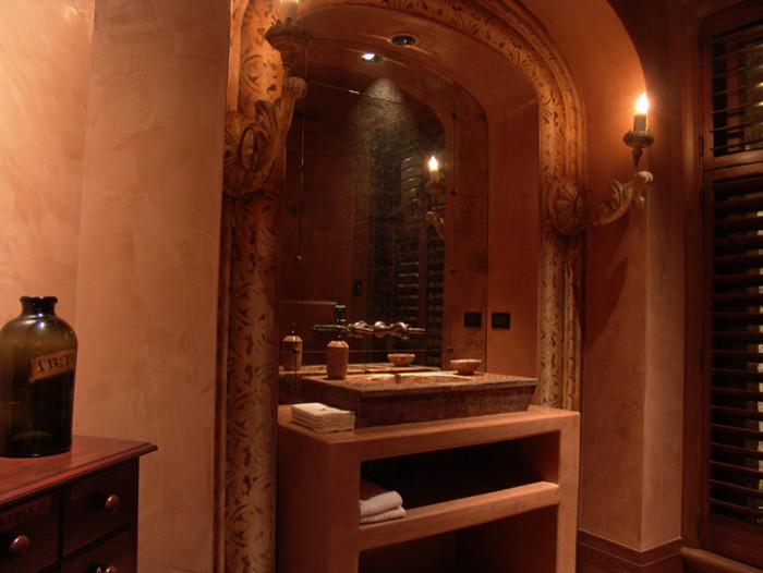 This is an example of a mid-sized mediterranean powder room in San Francisco with open cabinets, beige walls, beige cabinets and travertine benchtops.