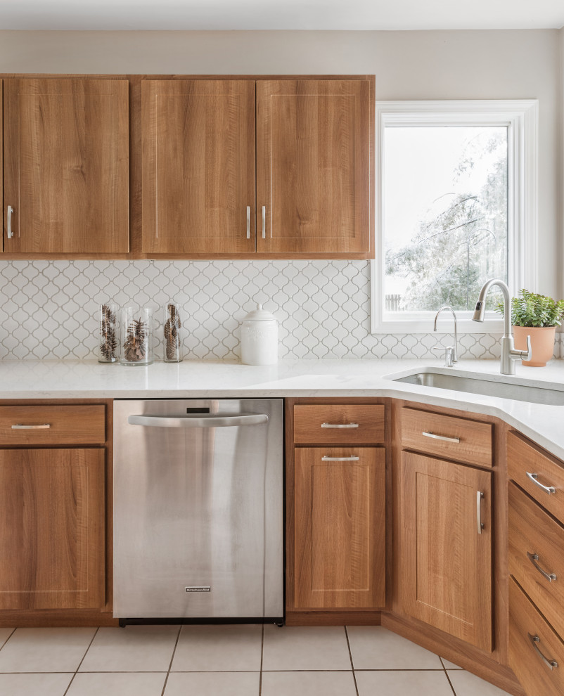Inspiration for a large transitional l-shaped cement tile floor and white floor eat-in kitchen remodel in Philadelphia with a single-bowl sink, flat-panel cabinets, medium tone wood cabinets, quartzite countertops, white backsplash, ceramic backsplash, stainless steel appliances, an island and white countertops