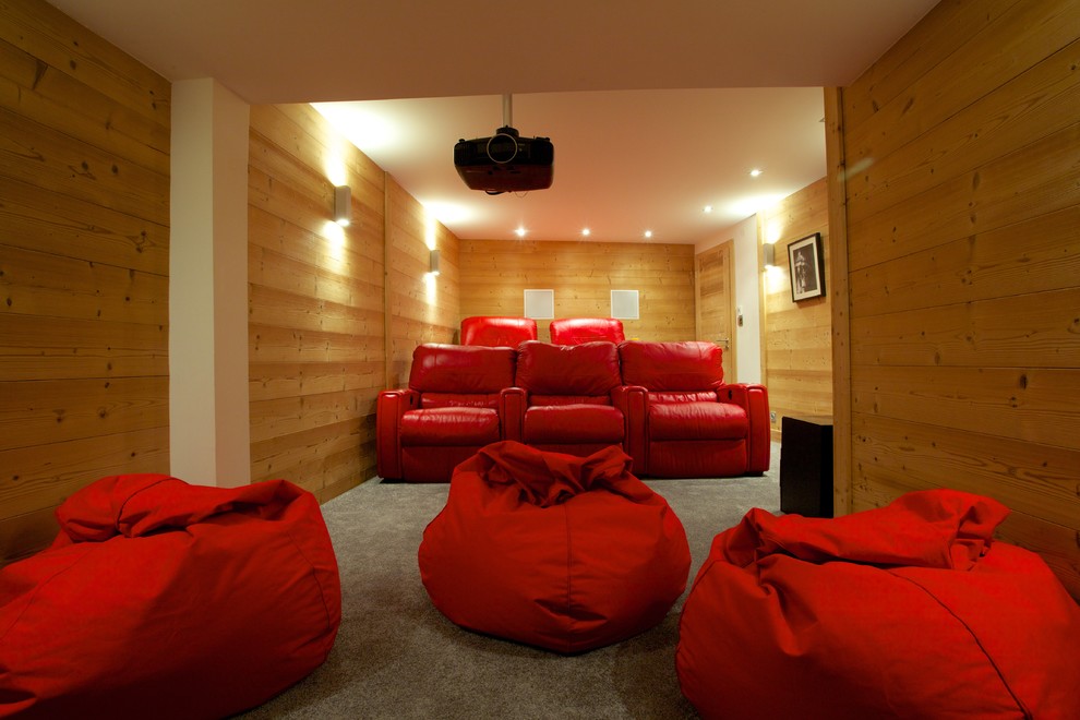 Design ideas for a large contemporary enclosed home theatre in Other with brown walls, carpet and a projector screen.