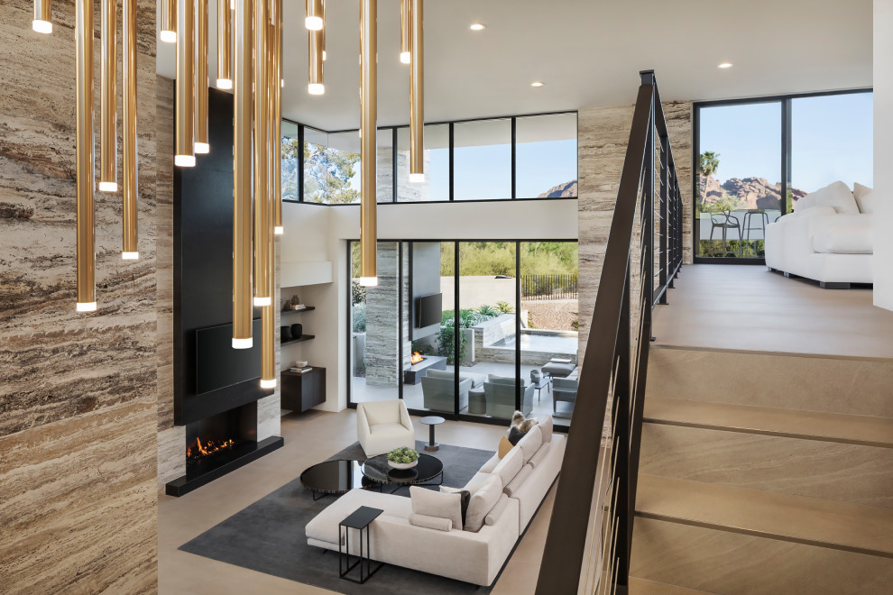 Стильный дизайн: огромная двухуровневая гостиная комната в стиле модернизм с бежевыми стенами, горизонтальным камином, фасадом камина из плитки, телевизором на стене и бежевым полом - последний тренд