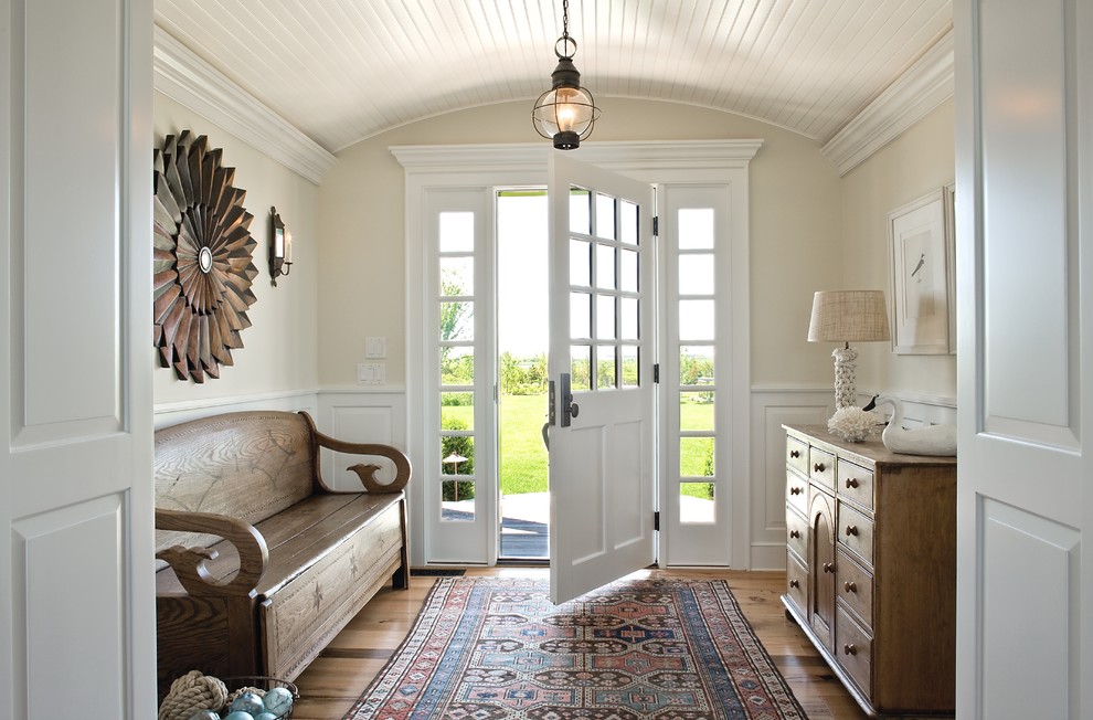 Inspiration for a beach style entry hall in Boston with beige walls, medium hardwood floors, a single front door, a white front door and brown floor.