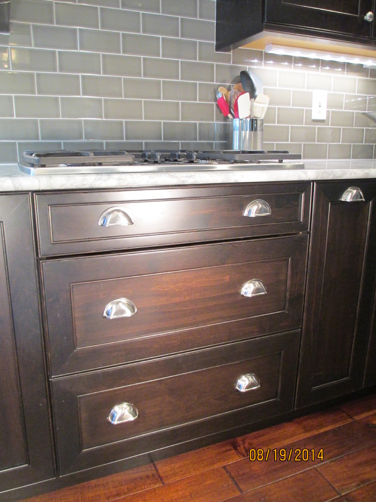 Inspiration for a mid-sized transitional u-shaped dark wood floor kitchen remodel in Denver with an undermount sink, shaker cabinets, dark wood cabinets, marble countertops, gray backsplash, subway tile backsplash, stainless steel appliances and an island