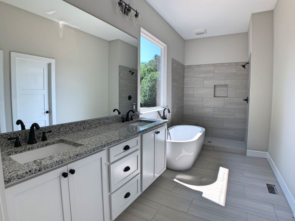 Example of a mid-sized farmhouse master gray tile and porcelain tile porcelain tile, gray floor and double-sink bathroom design in Atlanta with shaker cabinets, white cabinets, gray countertops and a built-in vanity