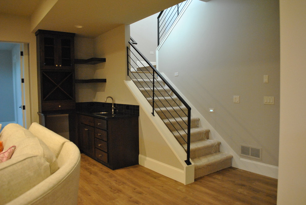 This is an example of a mid-sized contemporary carpeted u-shaped staircase in Denver with carpet risers.